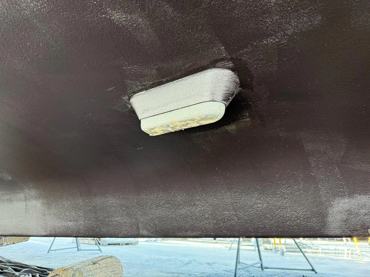 A close-up view of the yacht's hull with a focus on a small component attached to it. aboard FANTASEA Yacht for Sale