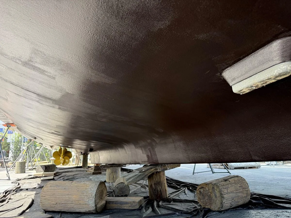 The image shows the underside of a yacht, likely during maintenance or repair work. aboard FANTASEA Yacht for Sale