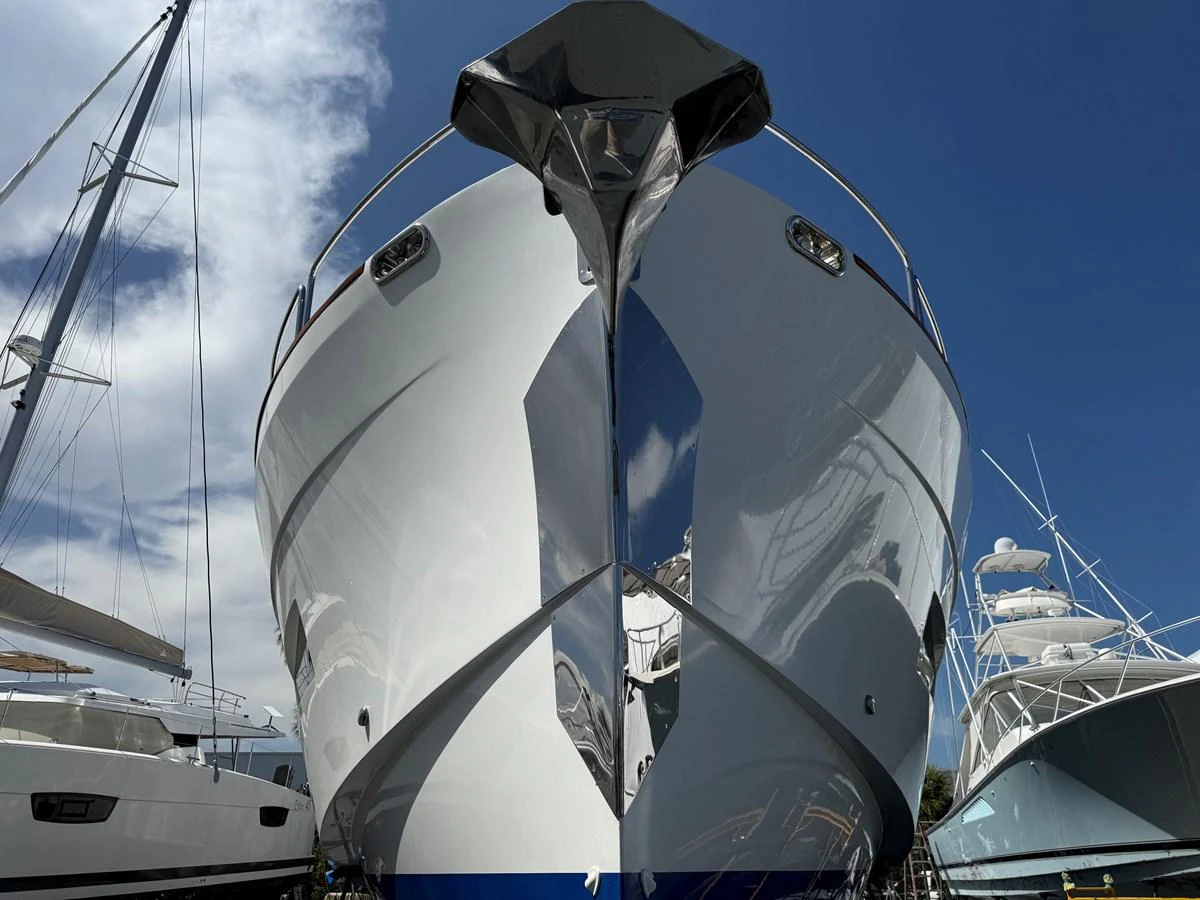 A striking head-on view of a sleek yacht docked under a clear blue sky. aboard FANTASEA Yacht for Sale
