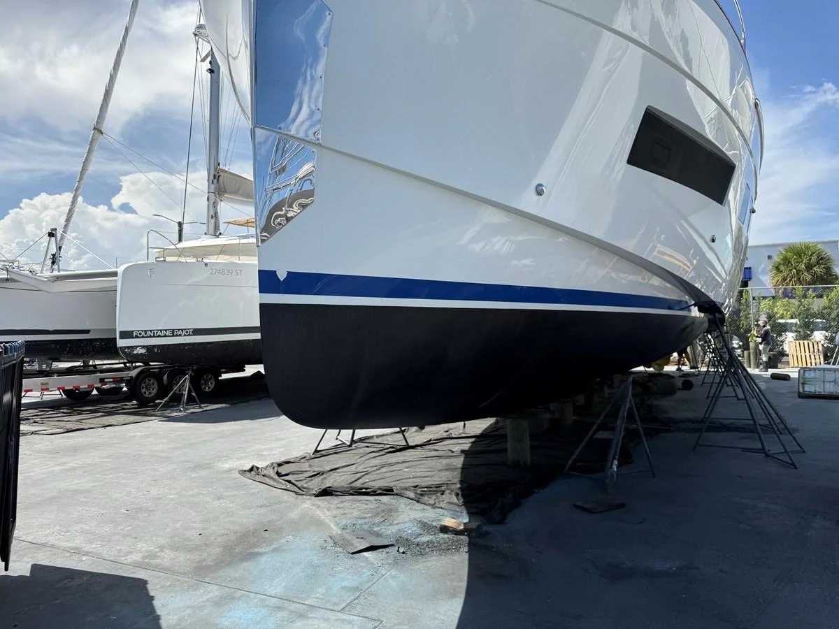 The yacht is positioned on land, showcasing its sleek hull and modern design. aboard FANTASEA Yacht for Sale