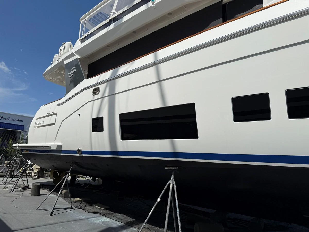 The yacht is shown out of the water, supported by stands, highlighting its sleek hull design. aboard FANTASEA Yacht for Sale