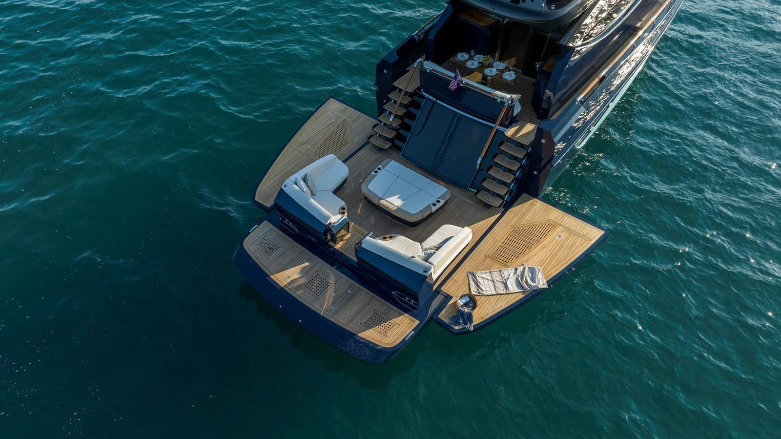 The yacht's aft deck features a spacious swim platform with luxurious sun loungers and easy access to the water. aboard NEW BUILD Yacht for Sale
