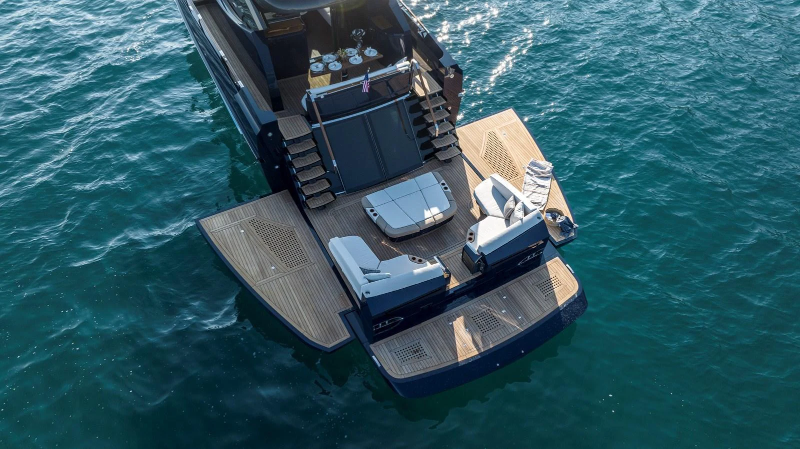 The yacht's aft deck features a spacious lounging area with direct access to the water. aboard NEW BUILD Yacht for Sale