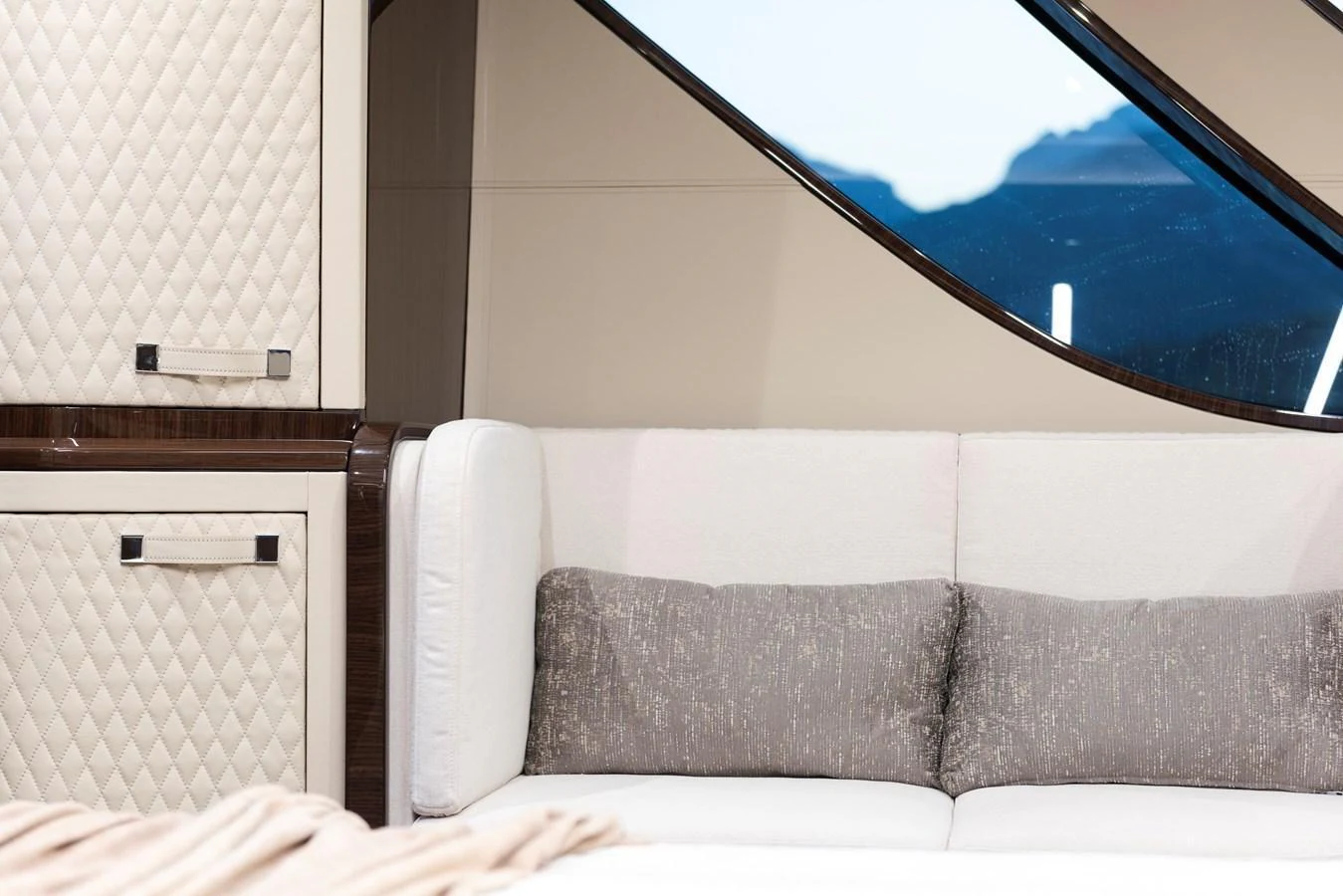 A luxurious interior space featuring a plush sofa with elegant cushions and stylish cabinetry. aboard NEW BUILD Yacht for Sale