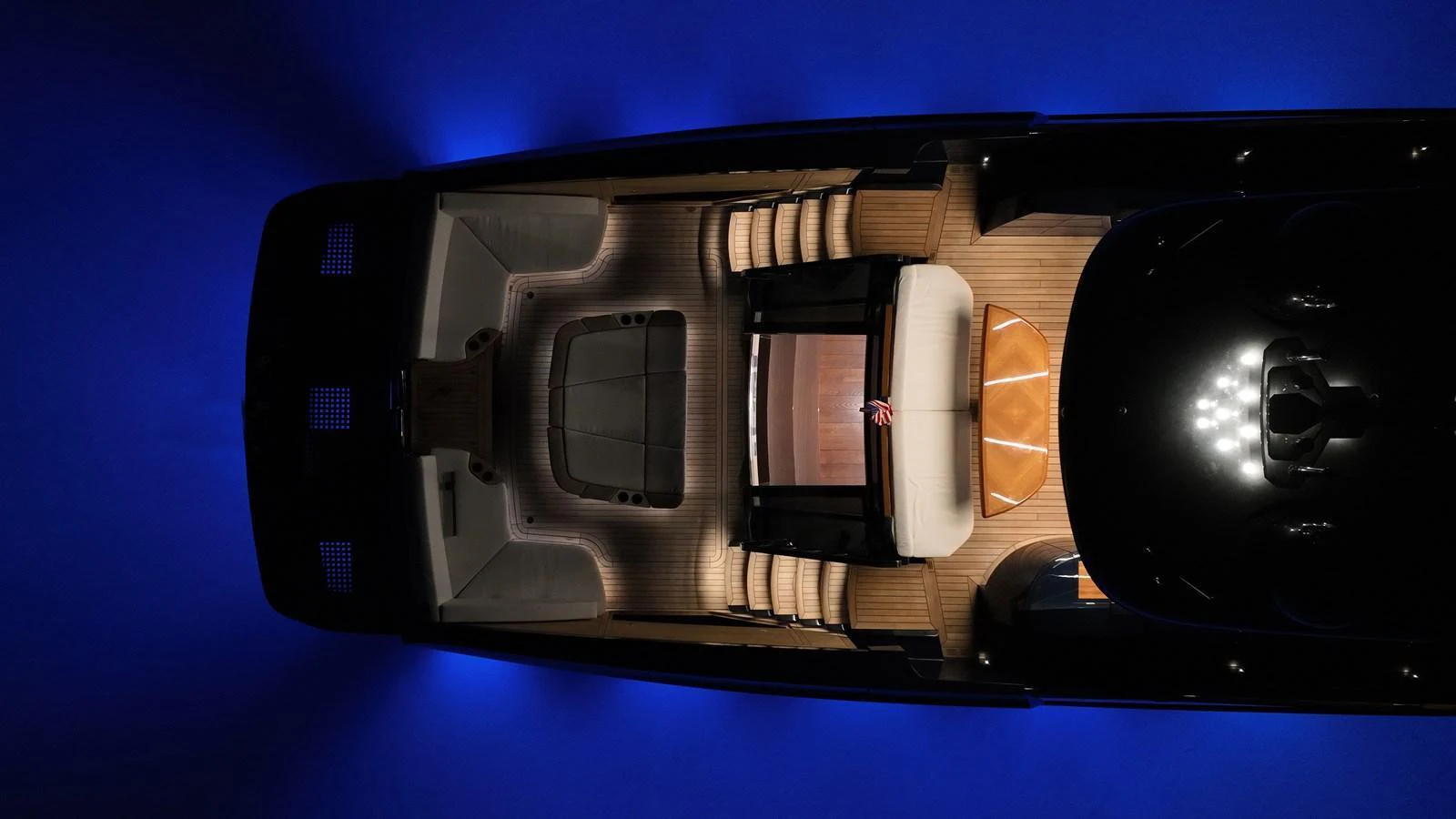 An aerial view of the yacht's top deck illuminated with elegant lighting against a dark background. aboard NEW BUILD Yacht for Sale