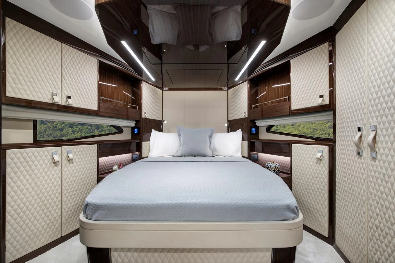 The stateroom features a luxurious bed with elegant quilted walls and ample storage space. aboard NEW BUILD Yacht for Sale