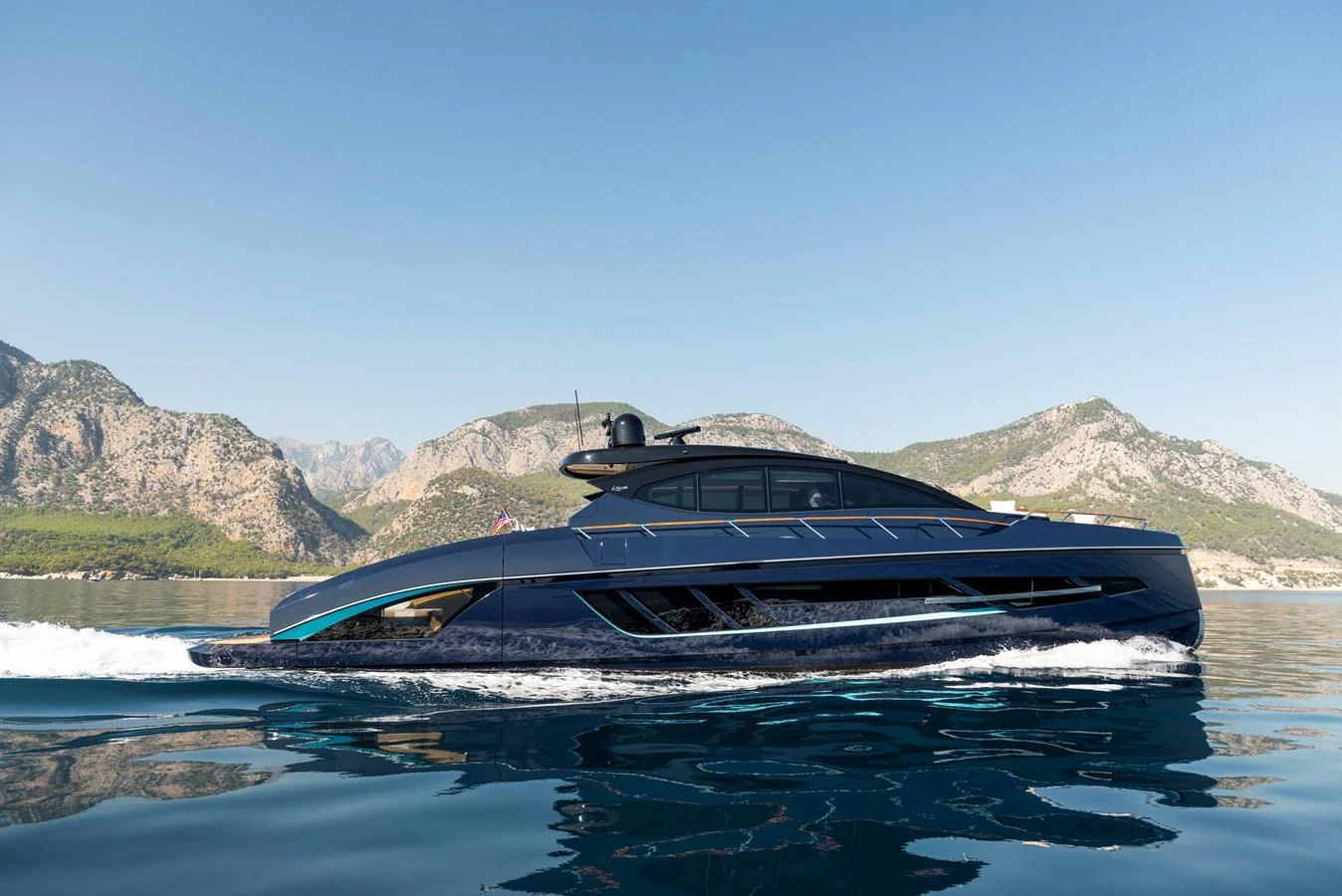 A sleek and modern yacht glides effortlessly on calm waters against a backdrop of majestic mountains. aboard NEW BUILD Yacht for Sale