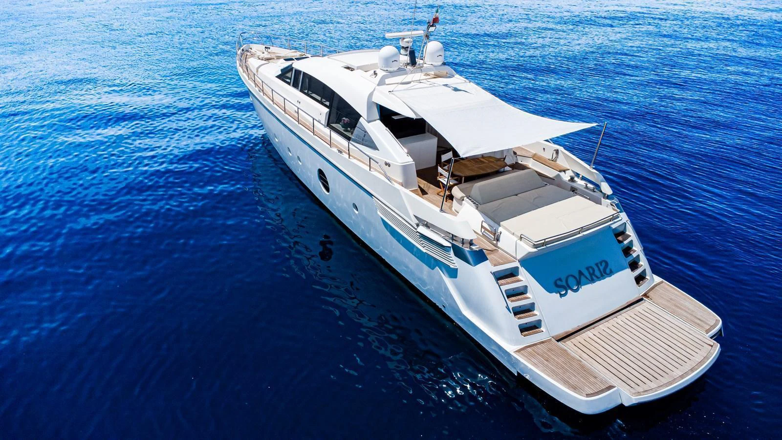 This sleek yacht showcases a spacious aft deck with a sunshade, perfect for relaxation on the water. aboard LUCHI Yacht for Sale
