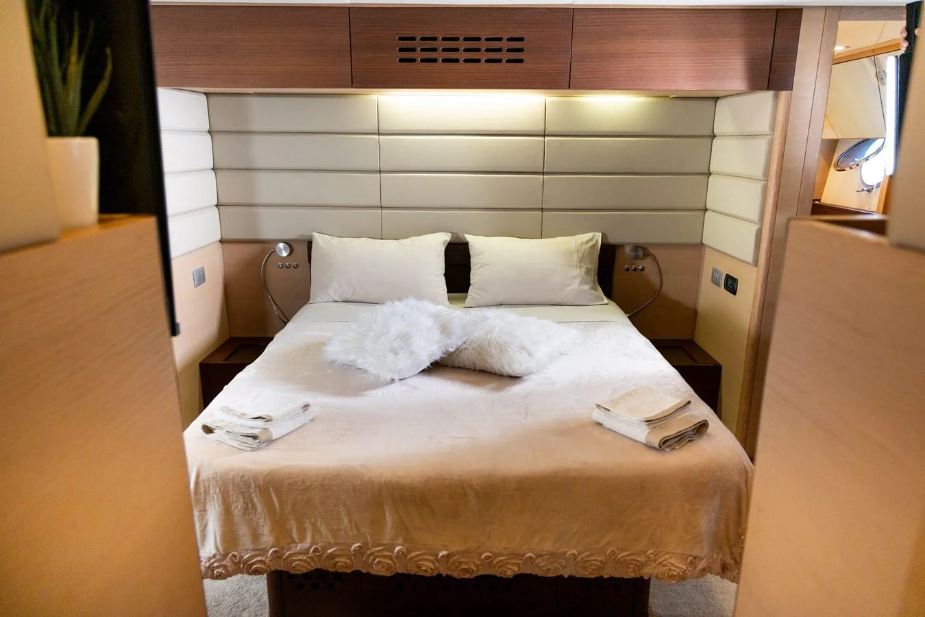 The stateroom features a cozy bed with plush pillows and soft lighting, creating a serene retreat. aboard LUCHI Yacht for Sale