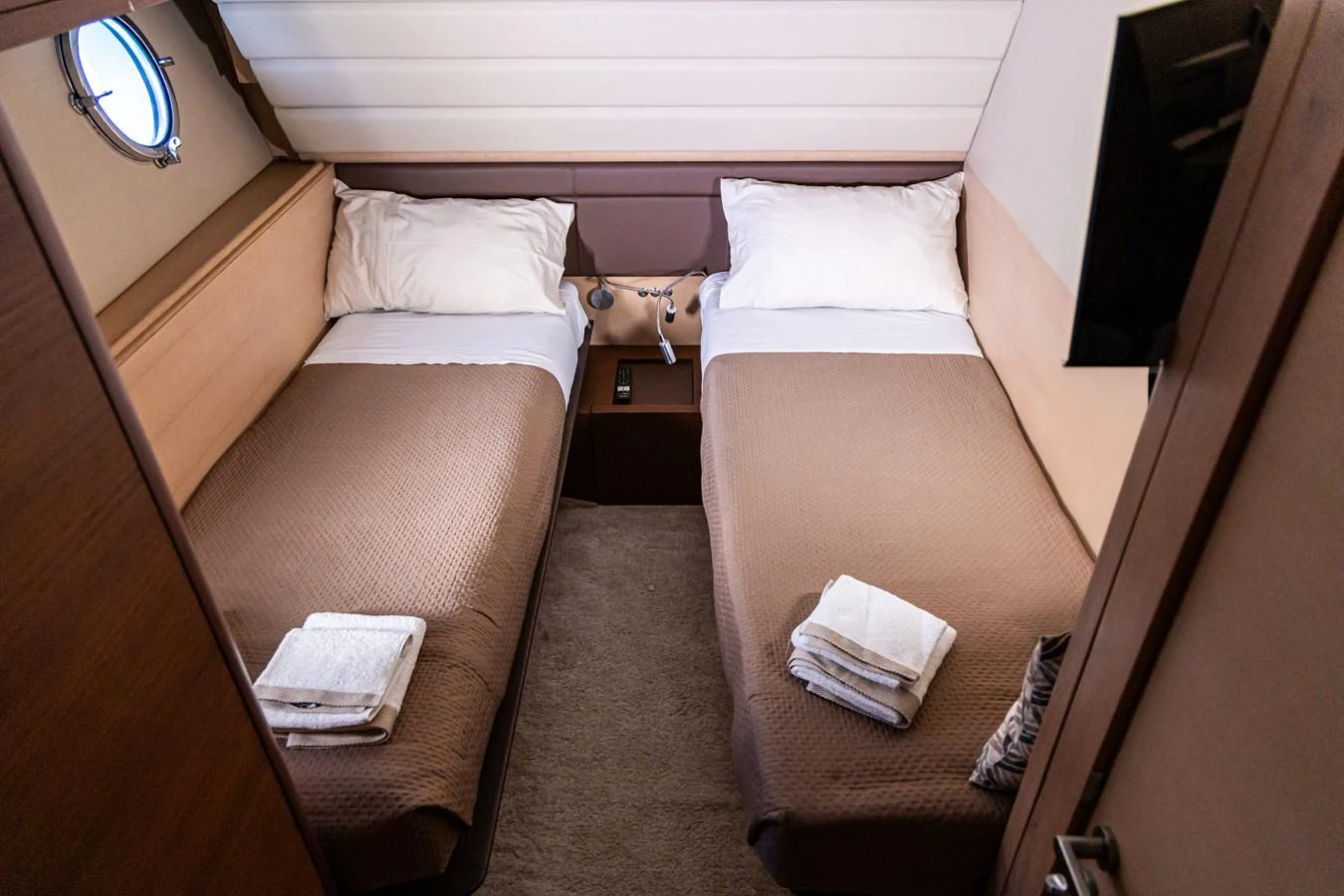 The twin stateroom features two single beds with a cozy and inviting atmosphere. aboard LUCHI Yacht for Sale