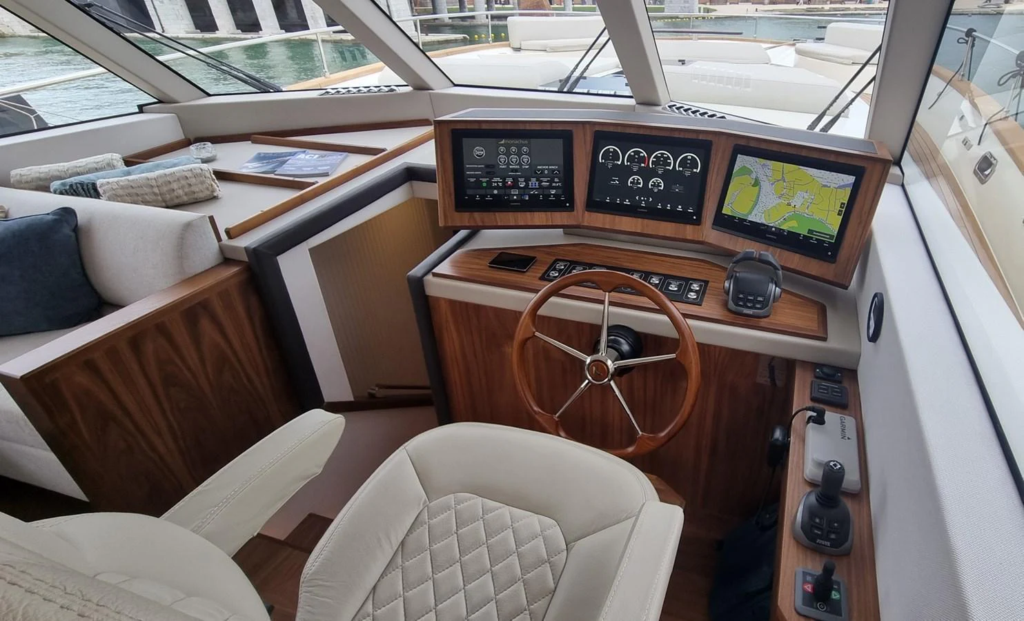 The helm station features modern navigation equipment and luxurious finishes. aboard MONACHUS 70 FLY Yacht for Sale