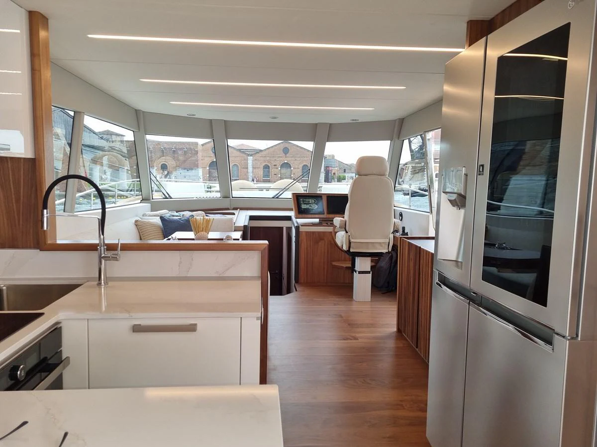 The modern galley and helm area offer a sleek and functional space with ample natural light. aboard MONACHUS 70 FLY Yacht for Sale