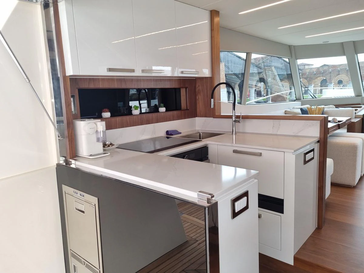 The modern galley features sleek cabinetry, high-end appliances, and ample counter space. aboard MONACHUS 70 FLY Yacht for Sale