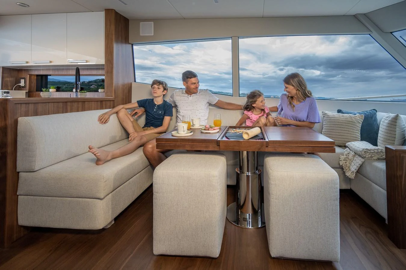 The saloon offers a cozy and inviting space for family gatherings with comfortable seating and panoramic views. aboard MONACHUS 70 FLY Yacht for Sale