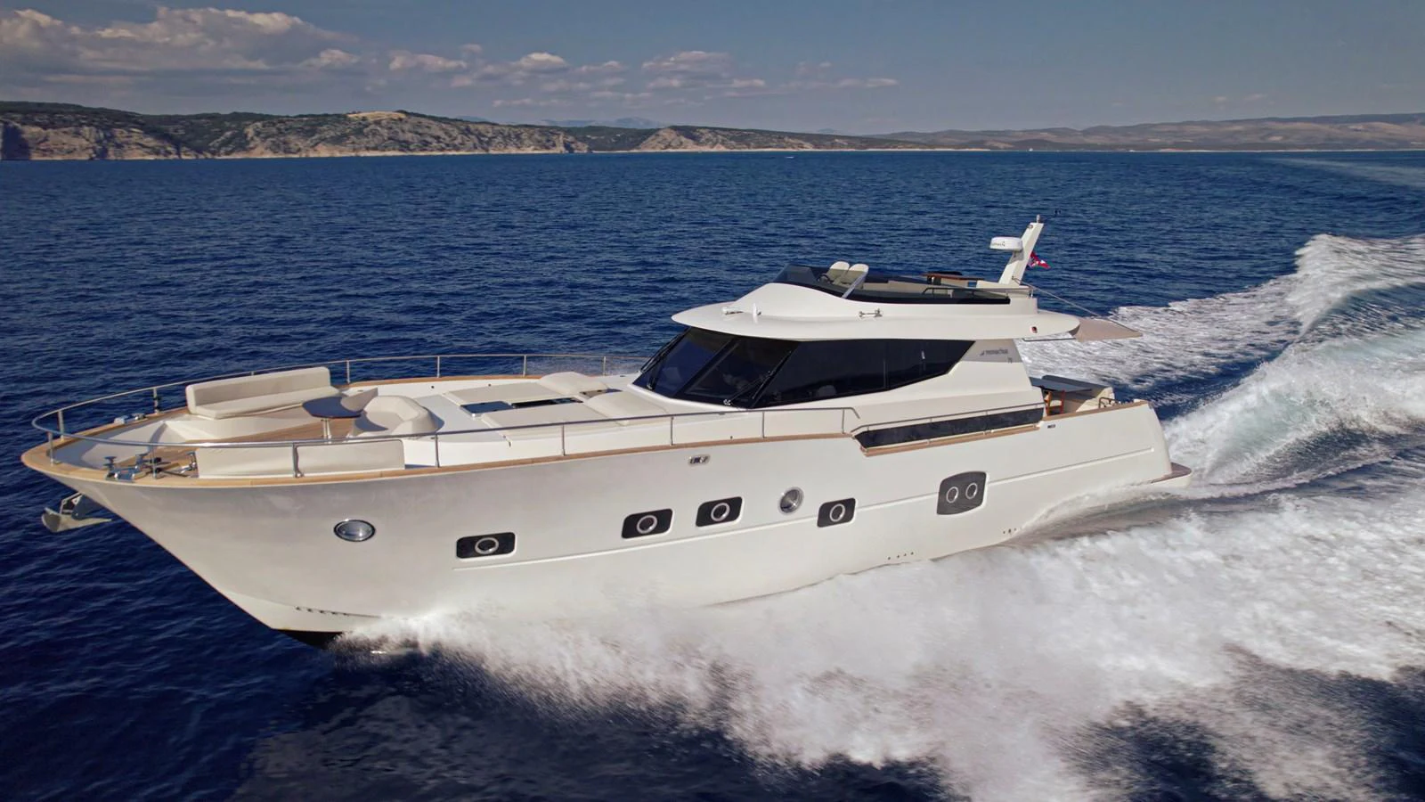 A sleek and modern yacht cruises through the open sea, showcasing its elegant design and powerful performance. aboard MONACHUS 70 FLY Yacht for Sale
