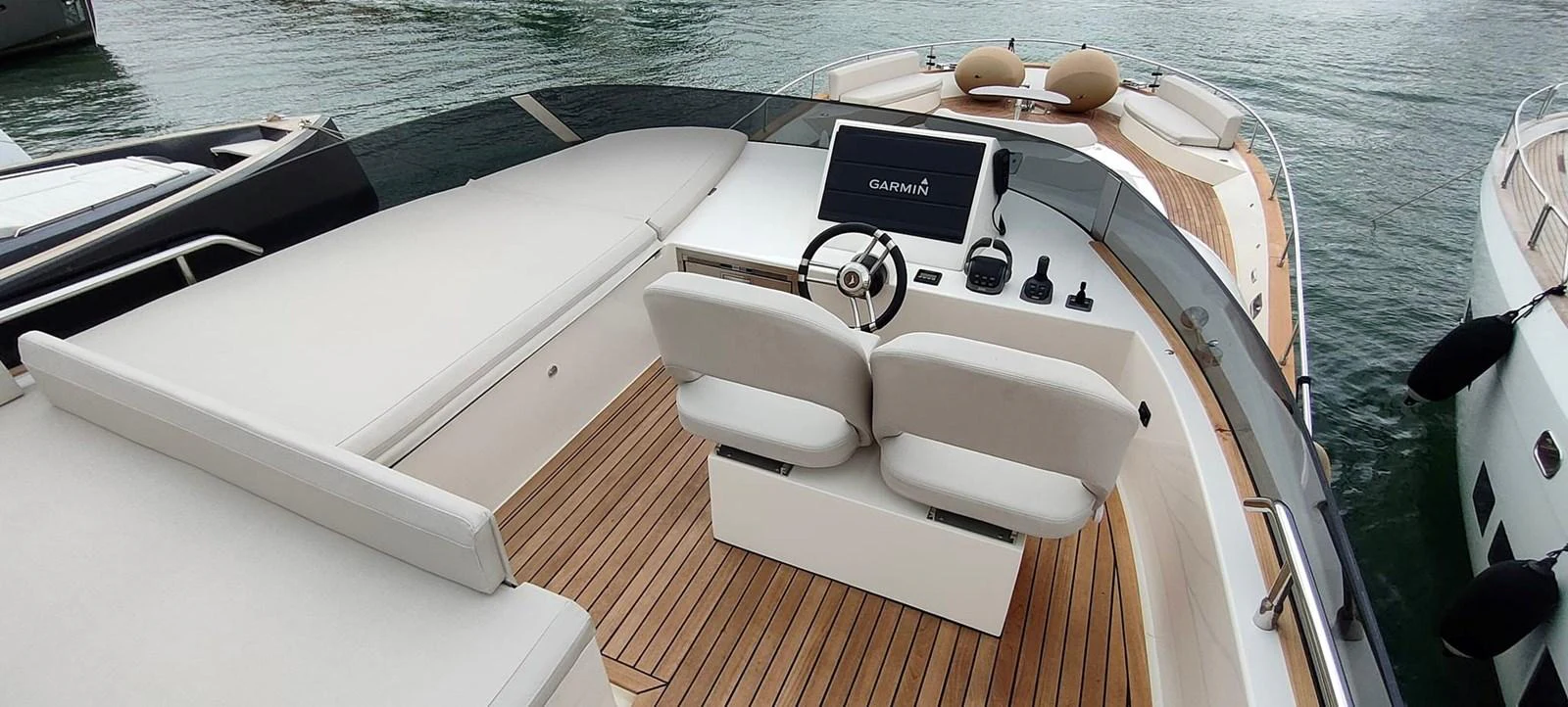 The yacht's helm area features a sleek design with modern navigation equipment and comfortable seating. aboard MONACHUS 70 FLY Yacht for Sale