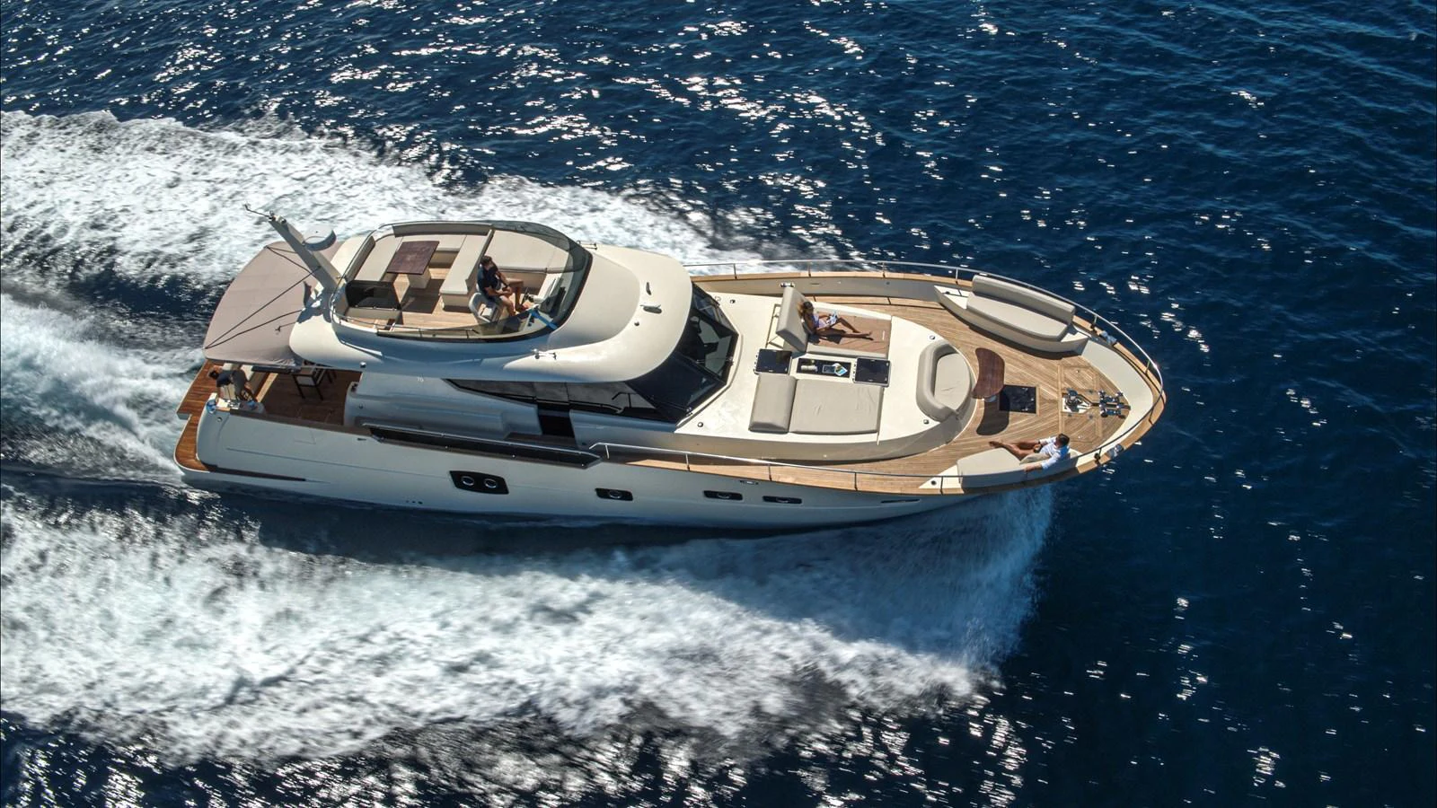 A sleek and modern yacht cruises swiftly through the deep blue sea, showcasing its elegant design and spacious deck areas. aboard MONACHUS 70 FLY Yacht for Sale