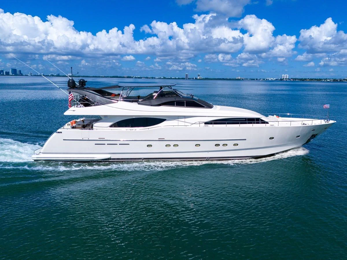 A sleek and modern yacht glides gracefully across calm waters under a bright blue sky. aboard FERRETTI YACHTS CUSTOM LINE 94 Yacht for Sale