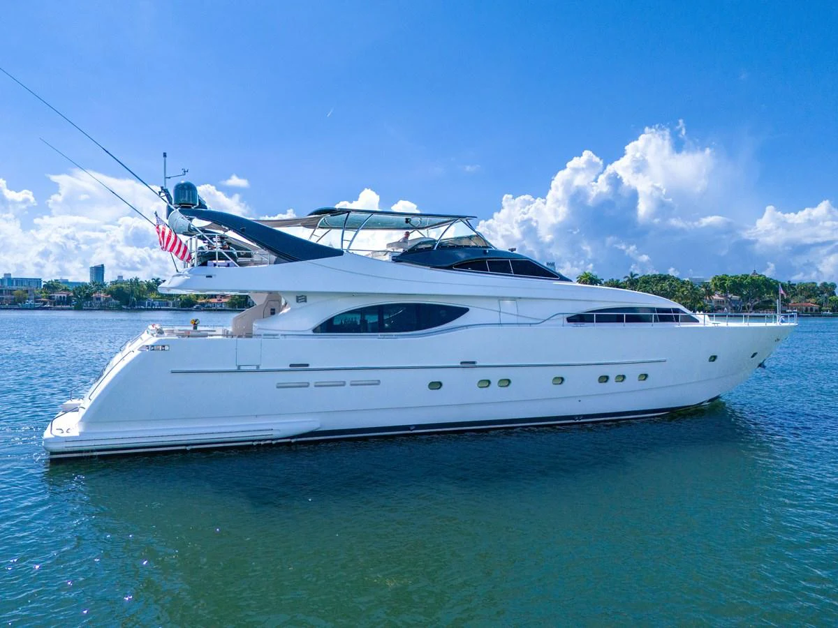 A sleek white yacht cruises gracefully on calm waters under a clear blue sky. aboard FERRETTI YACHTS CUSTOM LINE 94 Yacht for Sale
