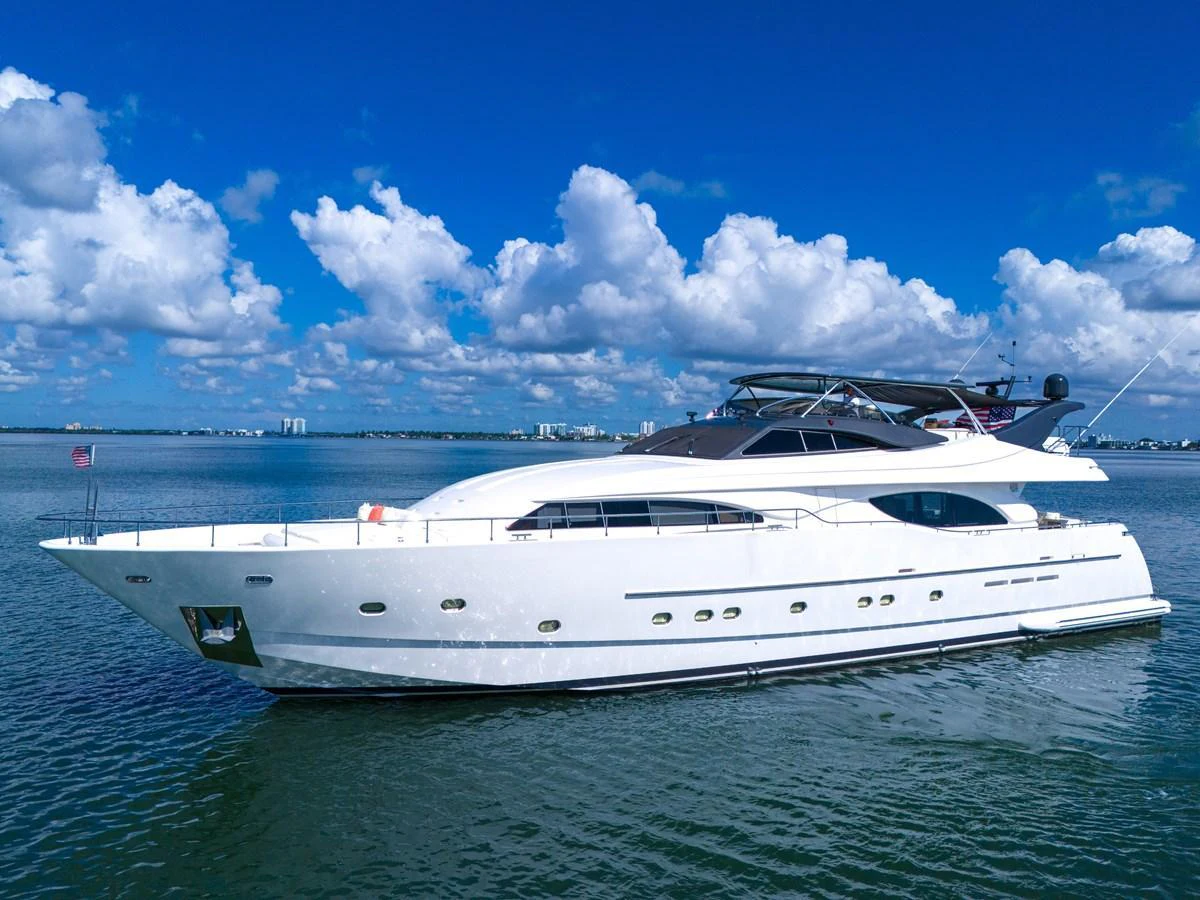 A sleek and modern yacht glides gracefully on calm waters under a bright blue sky. aboard FERRETTI YACHTS CUSTOM LINE 94 Yacht for Sale