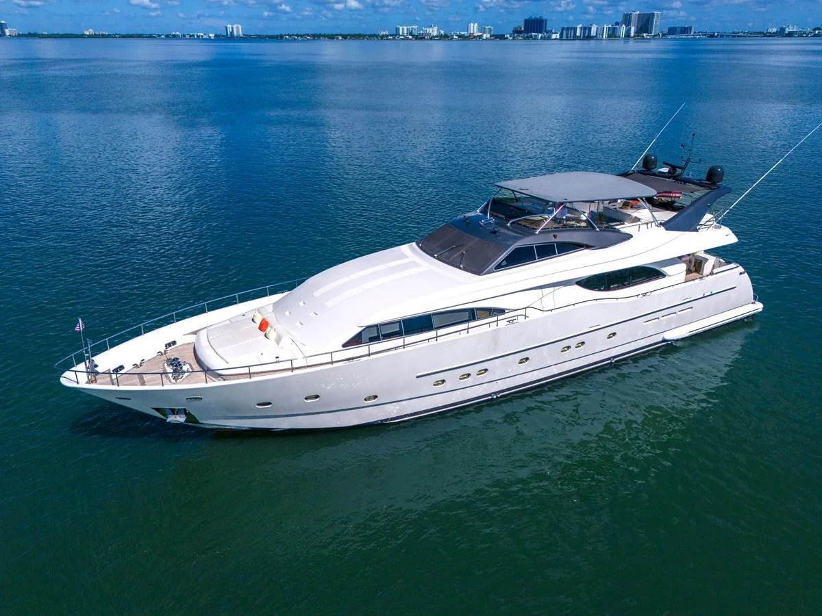 A sleek and modern yacht cruising on calm waters with a cityscape in the background. aboard FERRETTI YACHTS CUSTOM LINE 94 Yacht for Sale