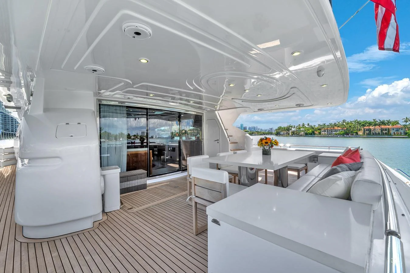The aft deck features a spacious seating area and dining table, perfect for enjoying meals with a view. aboard FERRETTI YACHTS CUSTOM LINE 94 Yacht for Sale