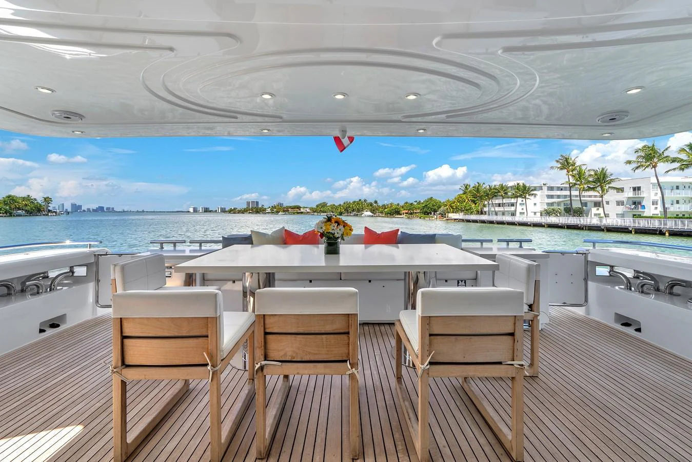 The aft deck features a spacious dining area with stunning waterfront views. aboard FERRETTI YACHTS CUSTOM LINE 94 Yacht for Sale