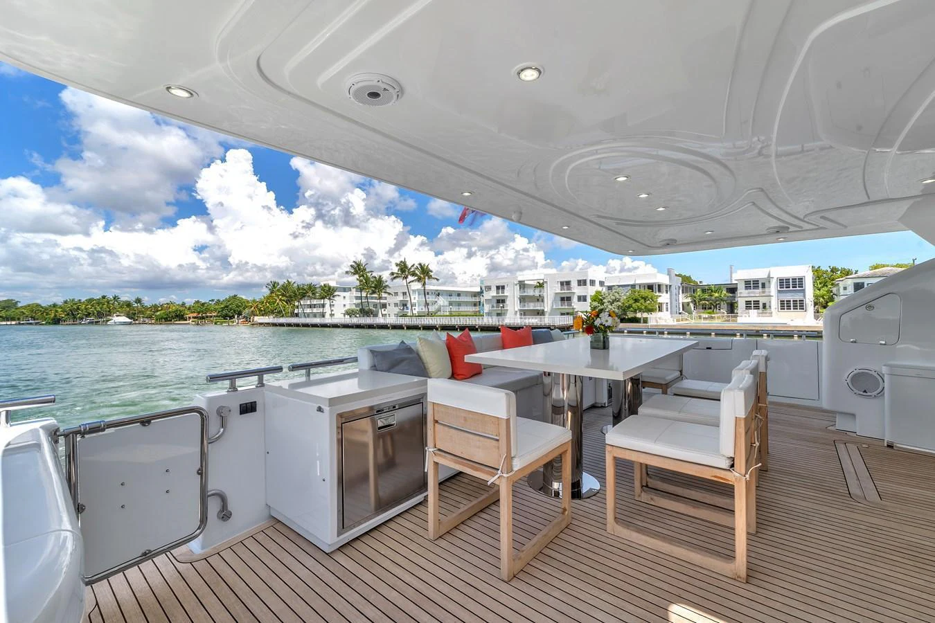 The aft deck features a spacious seating area with a dining table, perfect for alfresco meals and relaxation. aboard FERRETTI YACHTS CUSTOM LINE 94 Yacht for Sale