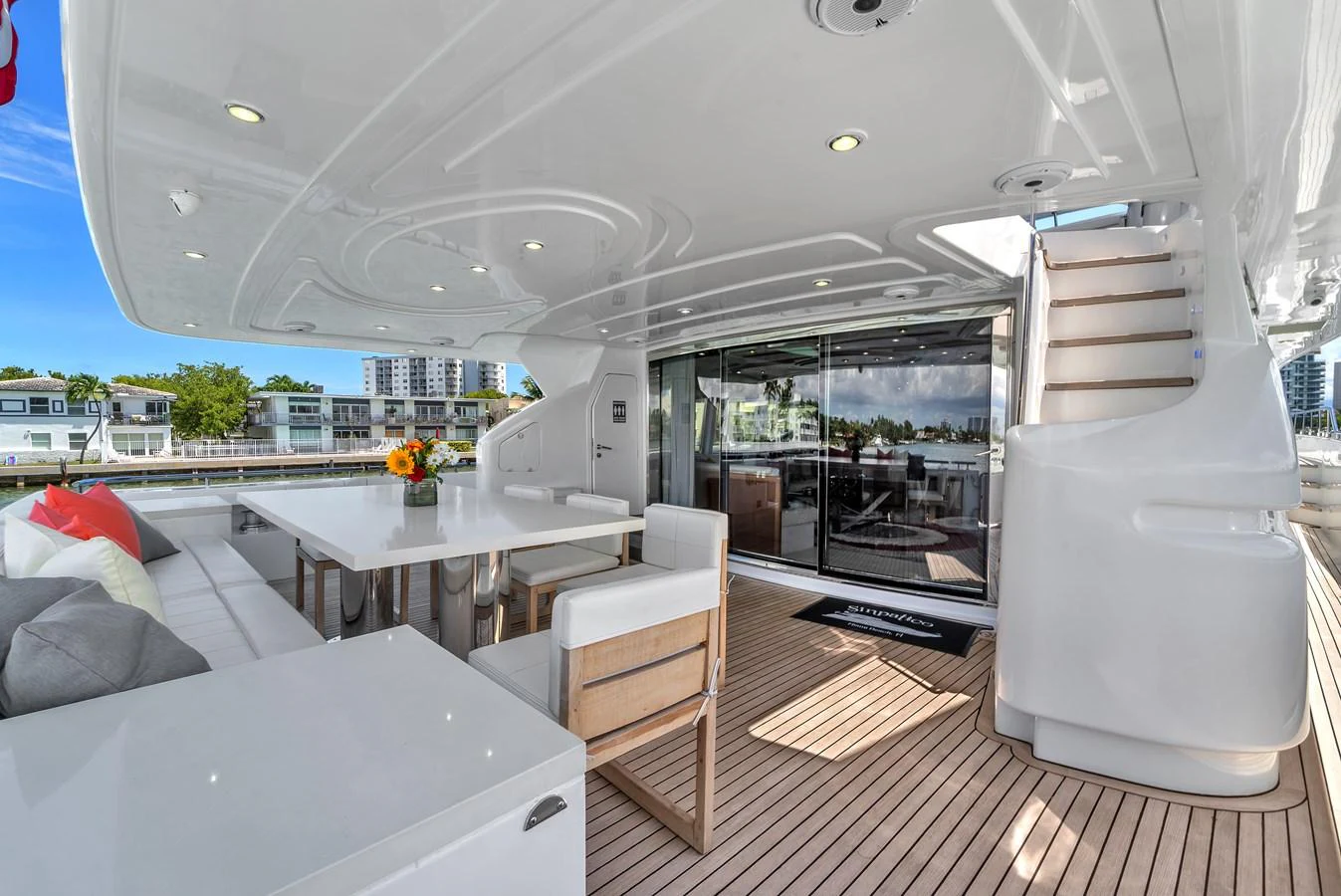 The aft deck features a spacious seating area with a dining table, perfect for alfresco meals. aboard FERRETTI YACHTS CUSTOM LINE 94 Yacht for Sale