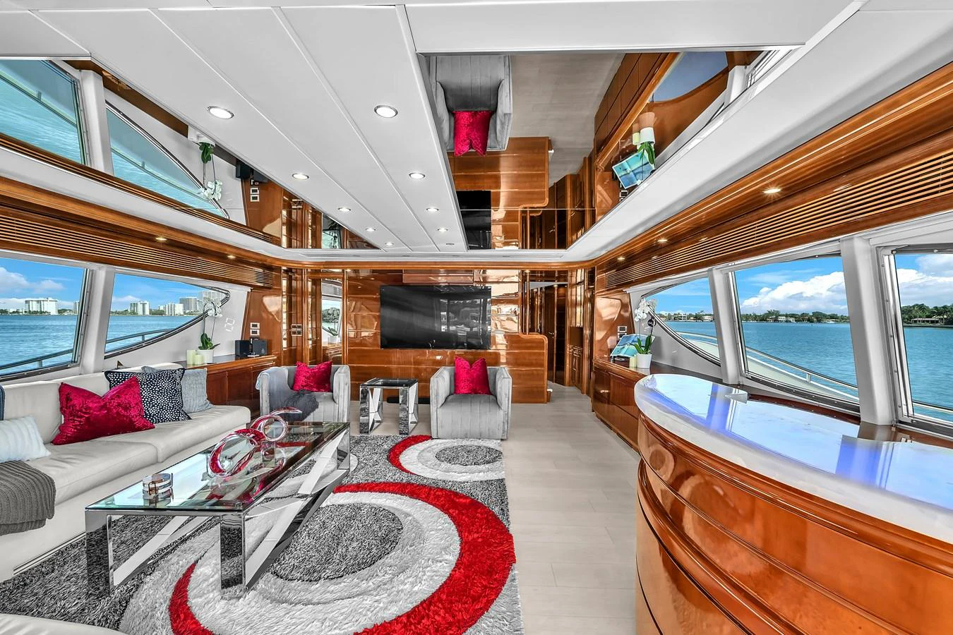 The yacht's interior features a spacious and modern living area with large windows offering stunning ocean views. aboard FERRETTI YACHTS CUSTOM LINE 94 Yacht for Sale