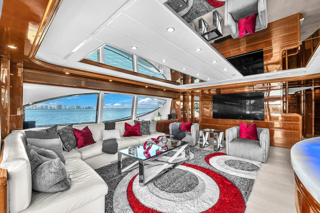 The salon features luxurious seating with vibrant accents and panoramic windows offering stunning ocean views. aboard FERRETTI YACHTS CUSTOM LINE 94 Yacht for Sale