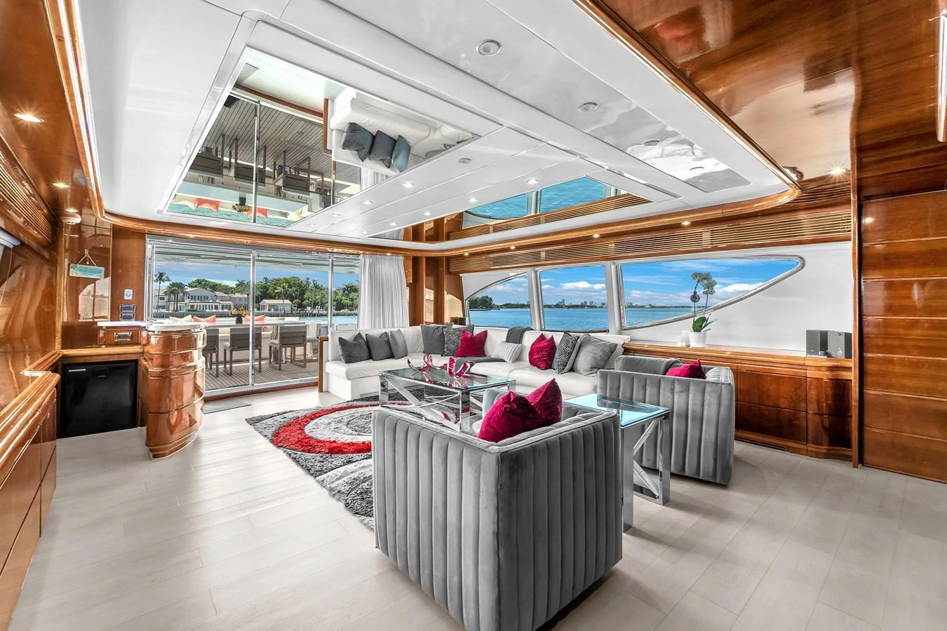 The salon features luxurious seating with panoramic views and elegant wood finishes. aboard FERRETTI YACHTS CUSTOM LINE 94 Yacht for Sale