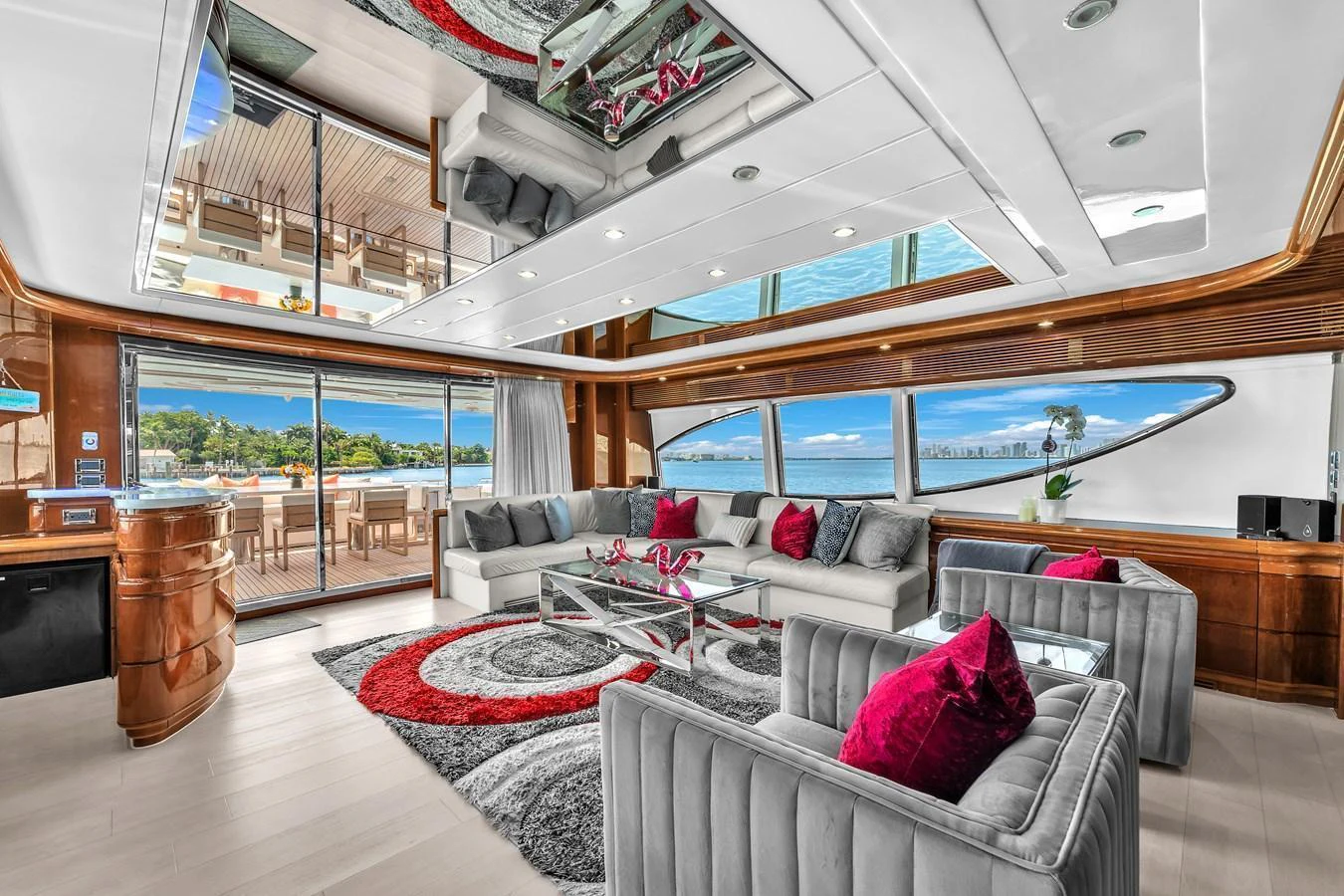 The yacht's salon features plush seating, vibrant decor, and expansive windows offering stunning views. aboard FERRETTI YACHTS CUSTOM LINE 94 Yacht for Sale