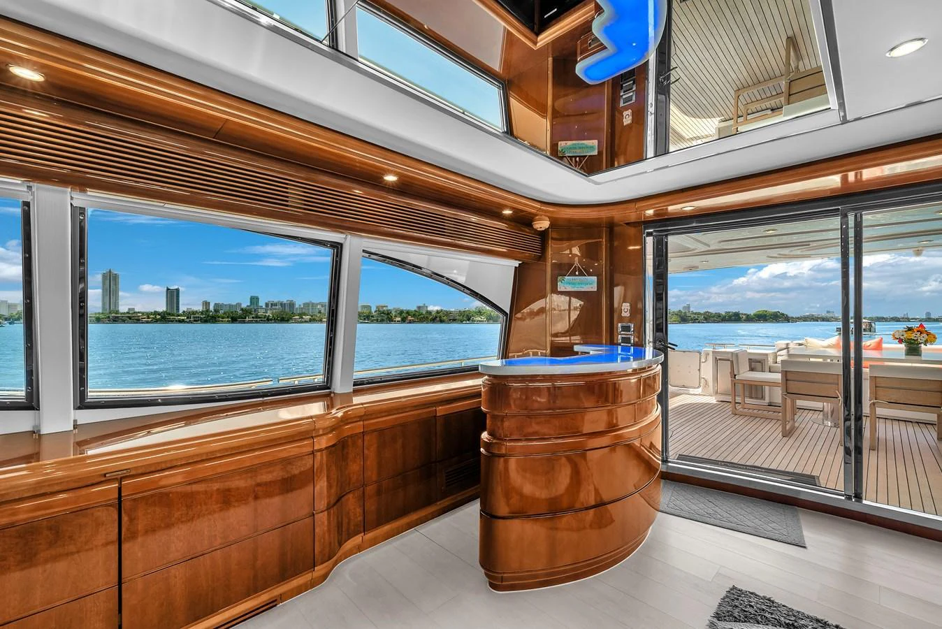 The yacht's salon features expansive windows and elegant wood finishes, offering stunning views and a luxurious atmosphere. aboard FERRETTI YACHTS CUSTOM LINE 94 Yacht for Sale