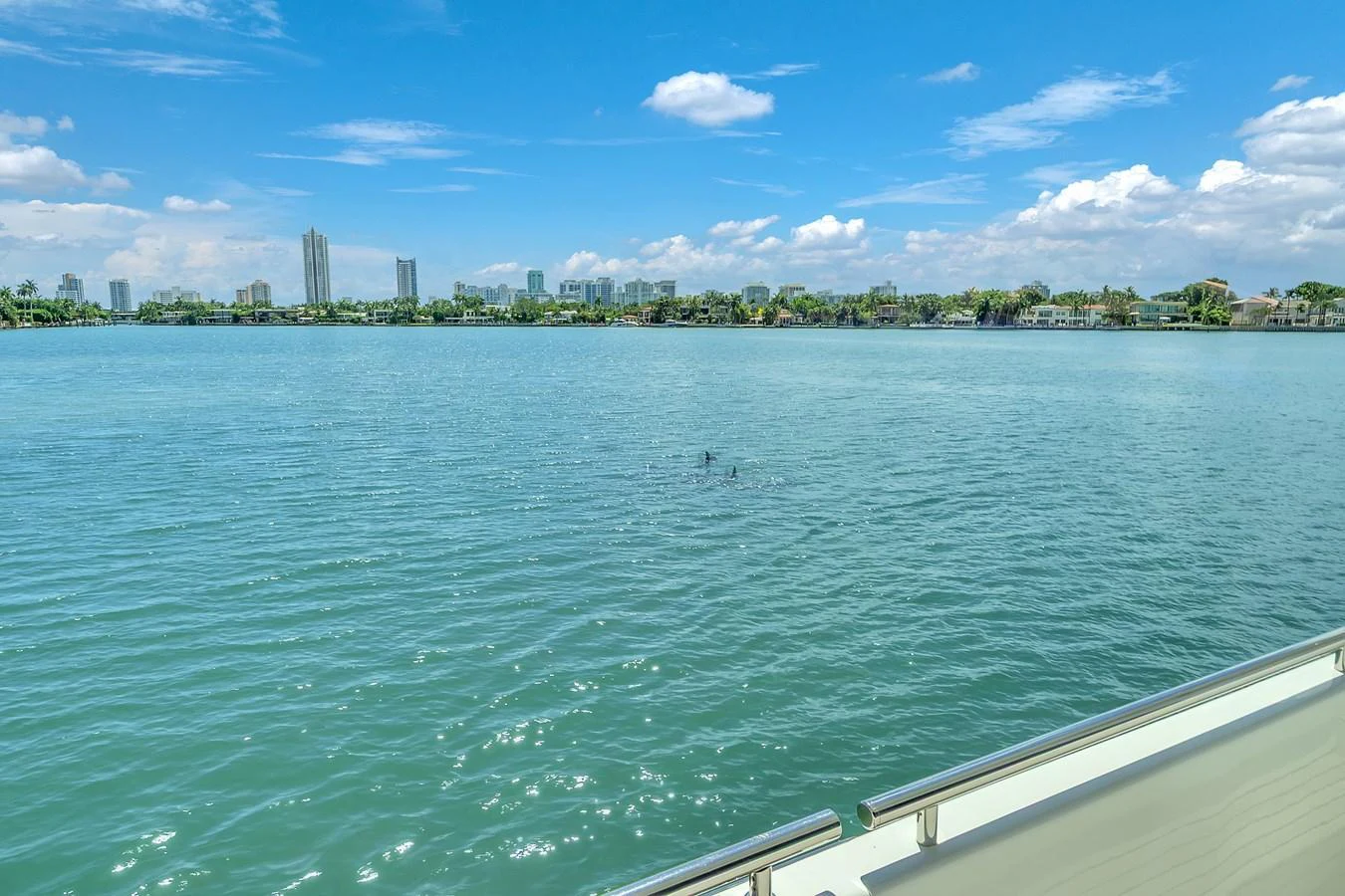 A serene view of the water from the yacht, with a cityscape in the distance. aboard FERRETTI YACHTS CUSTOM LINE 94 Yacht for Sale