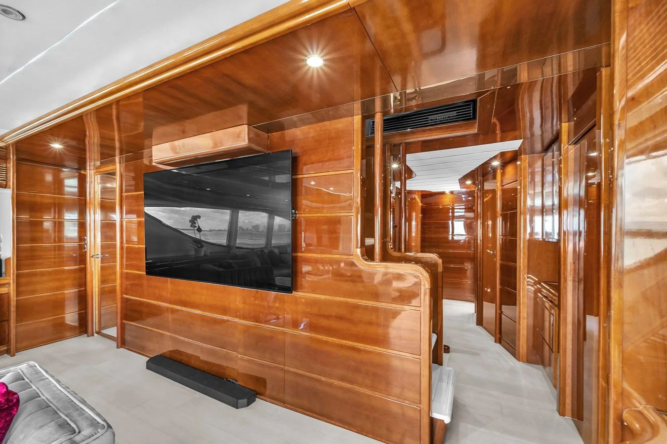 The yacht's interior features polished wooden walls and a large flat-screen TV, creating a warm and inviting atmosphere. aboard FERRETTI YACHTS CUSTOM LINE 94 Yacht for Sale