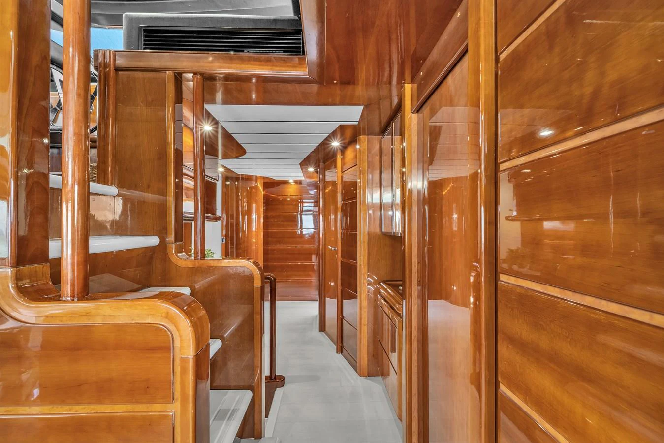 The yacht's interior features polished wooden walls and a sleek, modern design. aboard FERRETTI YACHTS CUSTOM LINE 94 Yacht for Sale