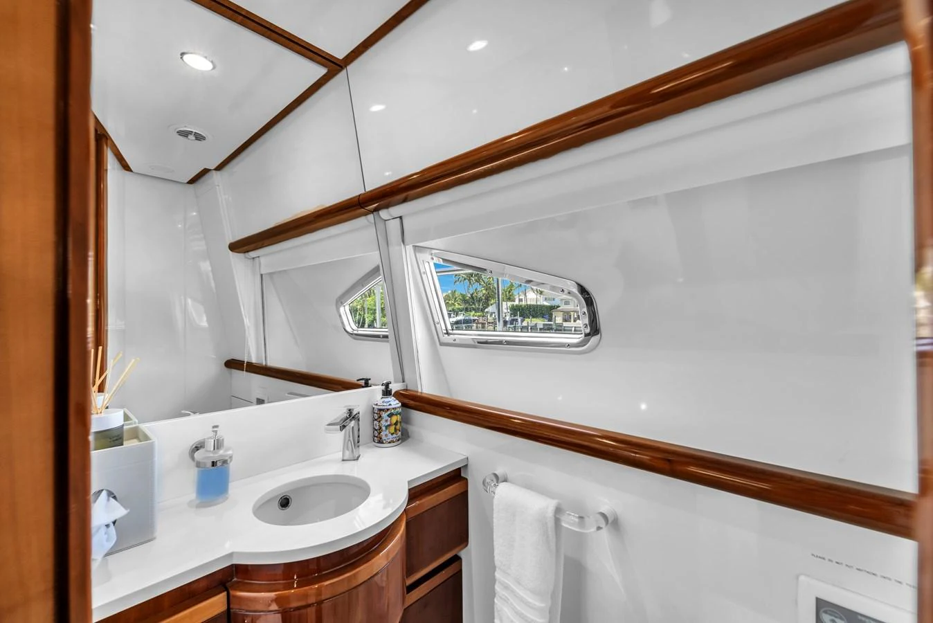 The yacht's bathroom features elegant wood accents and modern fixtures, with natural light streaming through the windows. aboard FERRETTI YACHTS CUSTOM LINE 94 Yacht for Sale