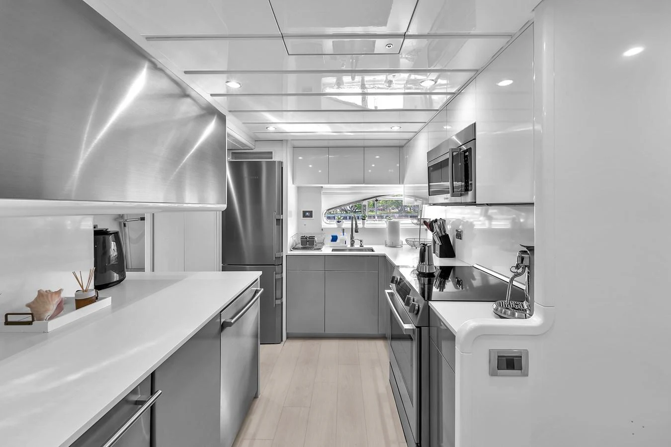 The sleek and modern galley features high-end appliances and ample counter space. aboard FERRETTI YACHTS CUSTOM LINE 94 Yacht for Sale