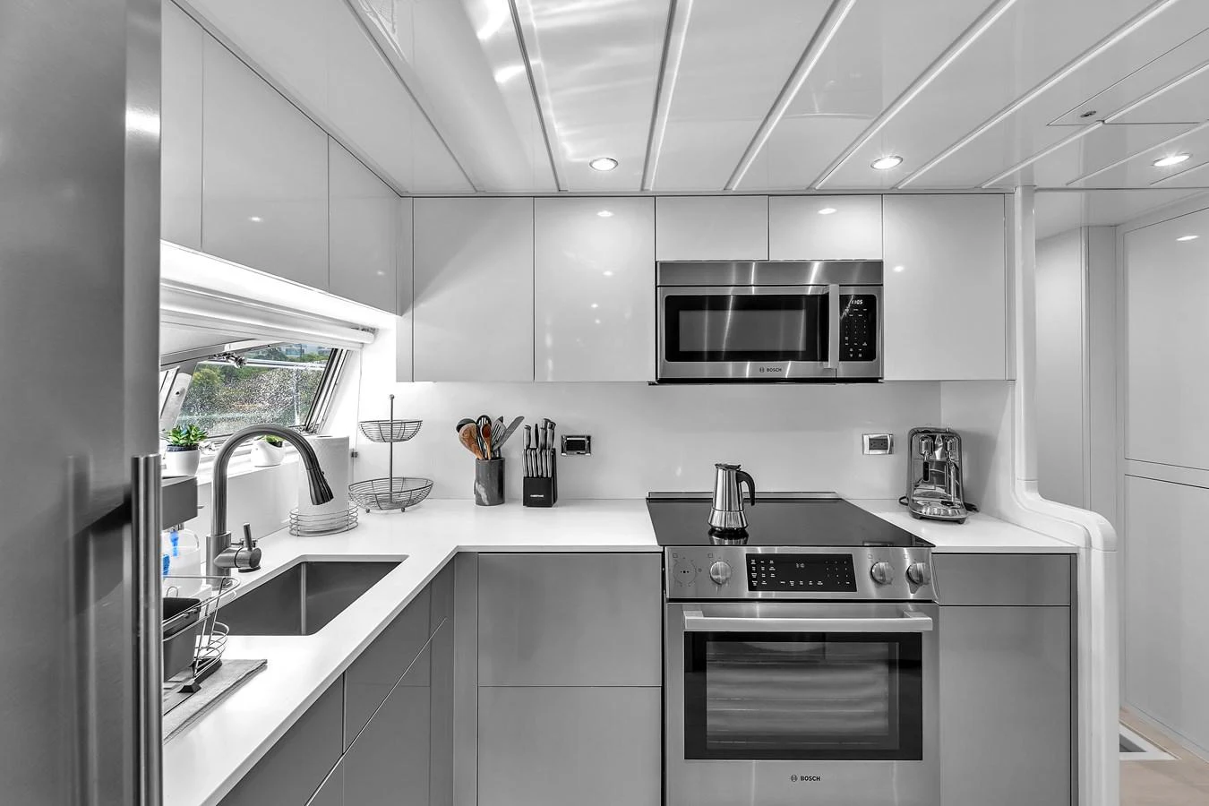 The yacht's galley is equipped with modern appliances and sleek cabinetry, offering a stylish and functional space for meal preparation. aboard FERRETTI YACHTS CUSTOM LINE 94 Yacht for Sale