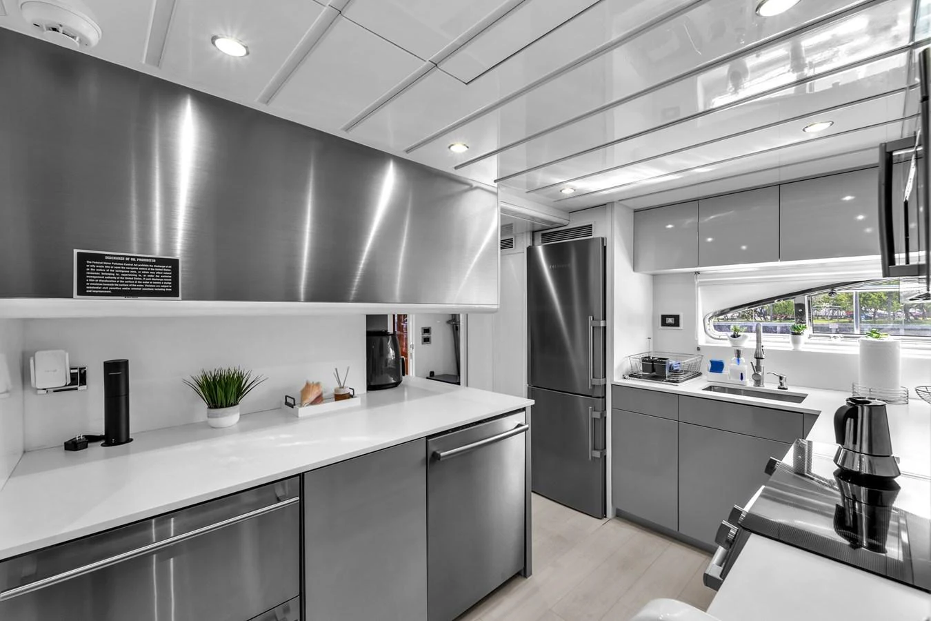 The yacht's galley features sleek stainless steel appliances and modern cabinetry, creating a stylish and functional space. aboard FERRETTI YACHTS CUSTOM LINE 94 Yacht for Sale