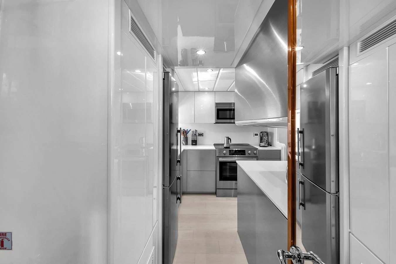 The yacht's galley features modern appliances and sleek cabinetry, creating a stylish and functional cooking space. aboard FERRETTI YACHTS CUSTOM LINE 94 Yacht for Sale