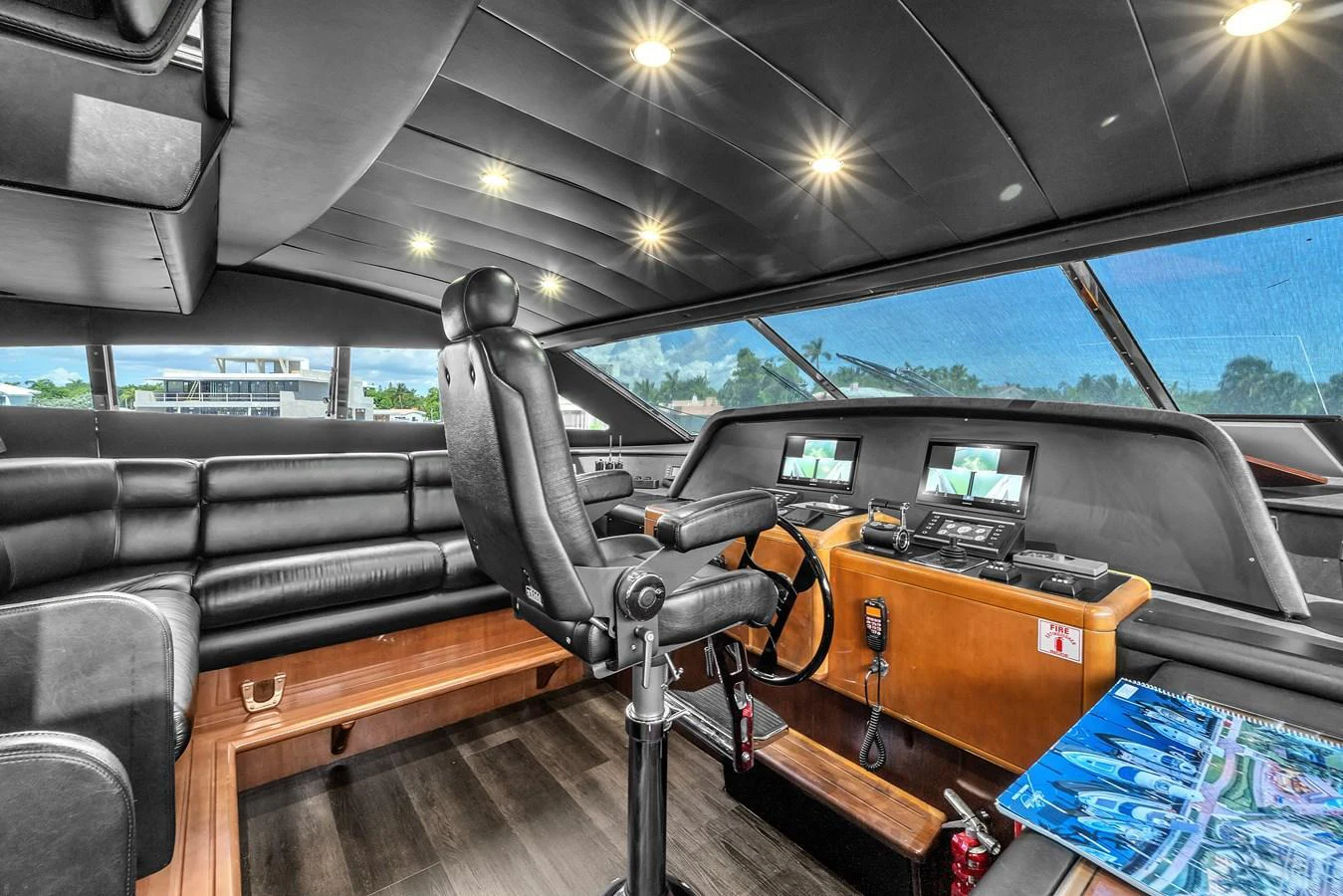 The helm station features modern navigation equipment and luxurious seating. aboard FERRETTI YACHTS CUSTOM LINE 94 Yacht for Sale