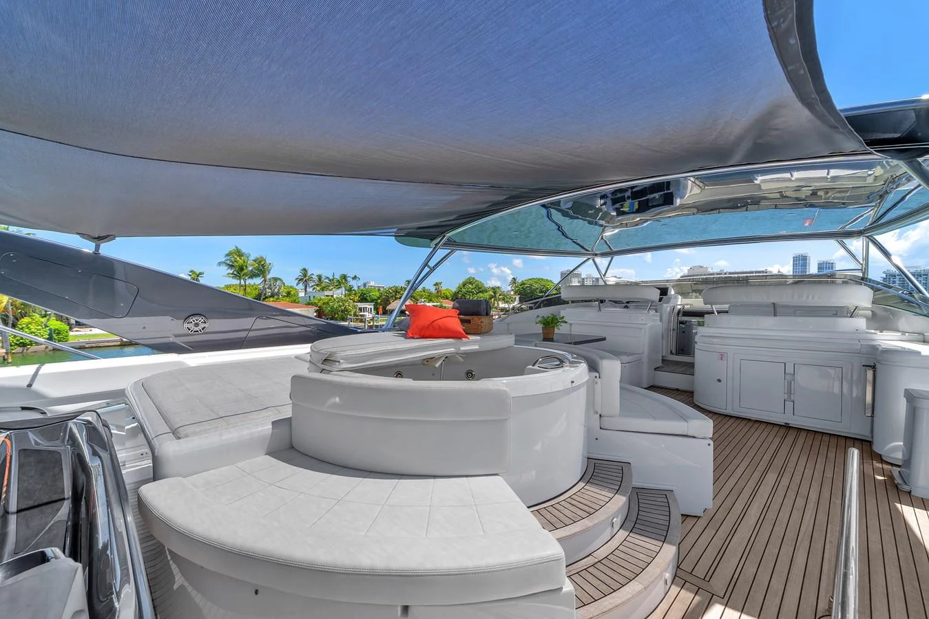 The flybridge features a spacious seating area with a hot tub, shaded by a sleek canopy. aboard FERRETTI YACHTS CUSTOM LINE 94 Yacht for Sale