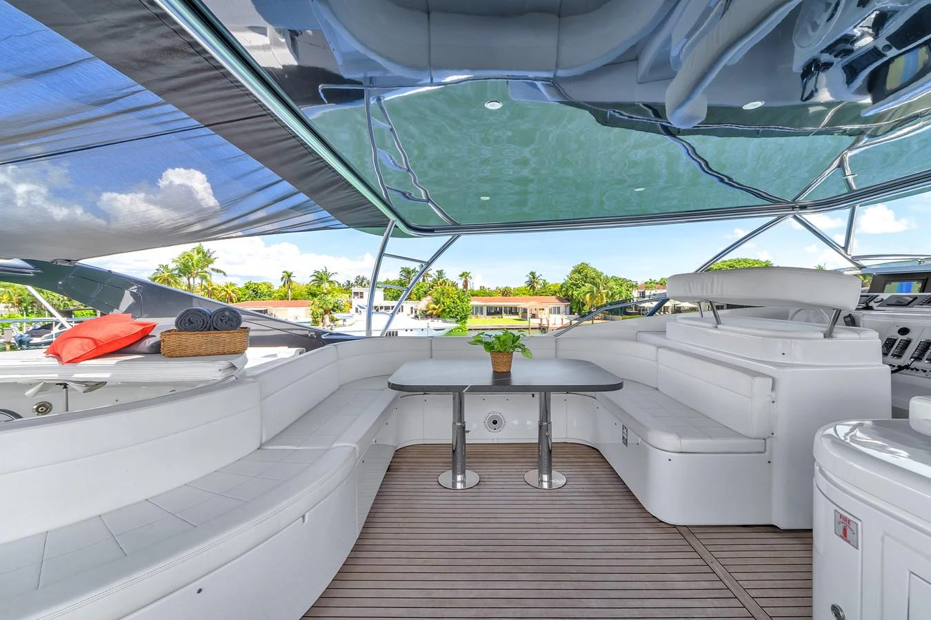 The flybridge offers a spacious seating area with a table, perfect for outdoor relaxation and dining. aboard FERRETTI YACHTS CUSTOM LINE 94 Yacht for Sale