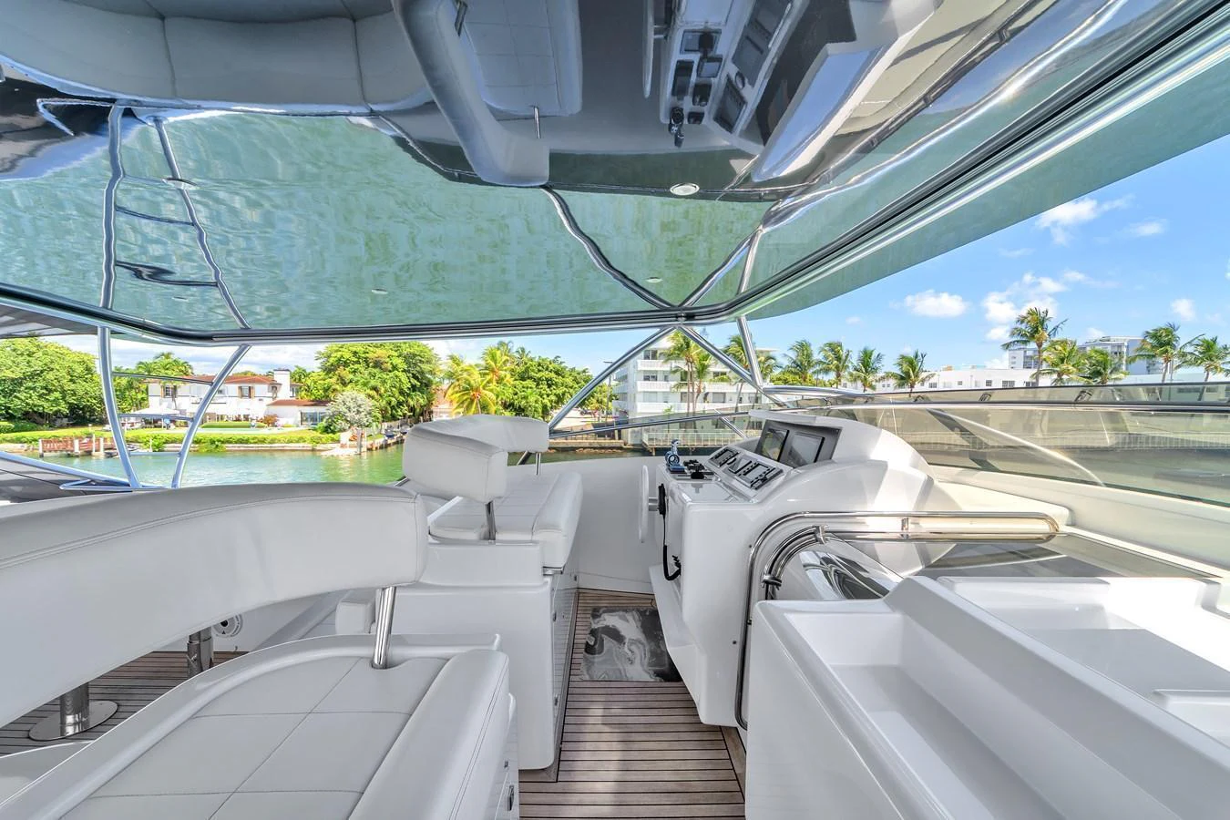 The helm area features modern controls and comfortable seating with a view of the surroundings. aboard FERRETTI YACHTS CUSTOM LINE 94 Yacht for Sale