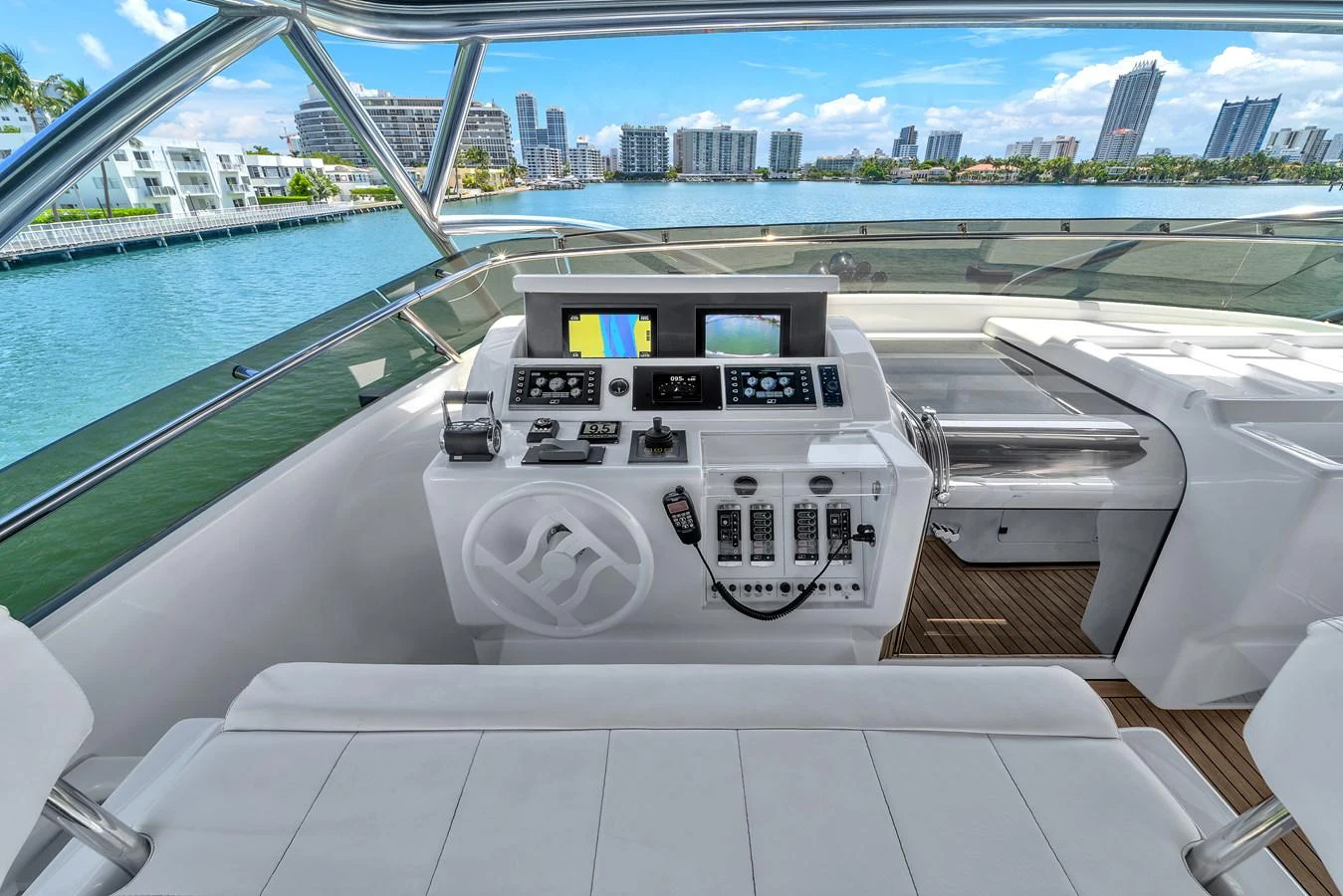 The helm station offers a modern and well-equipped control area with a scenic view of the city skyline. aboard FERRETTI YACHTS CUSTOM LINE 94 Yacht for Sale