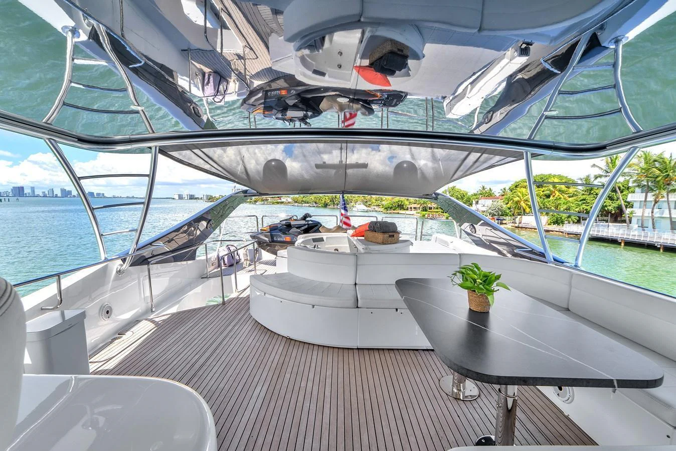The flybridge offers a spacious seating area with a table, perfect for enjoying the scenic views. aboard FERRETTI YACHTS CUSTOM LINE 94 Yacht for Sale