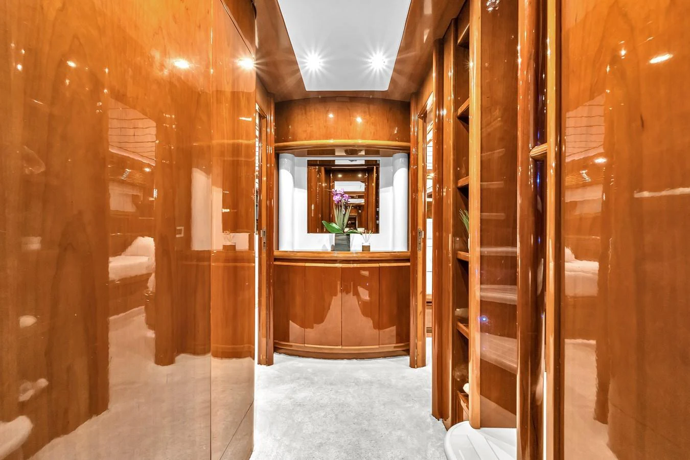 The yacht's interior features a polished wood hallway with elegant lighting and a luxurious ambiance. aboard FERRETTI YACHTS CUSTOM LINE 94 Yacht for Sale