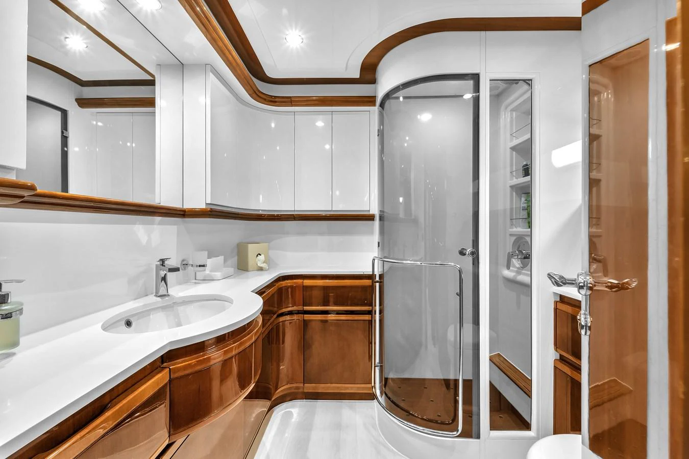 The yacht's bathroom features elegant wood accents and modern fixtures. aboard FERRETTI YACHTS CUSTOM LINE 94 Yacht for Sale